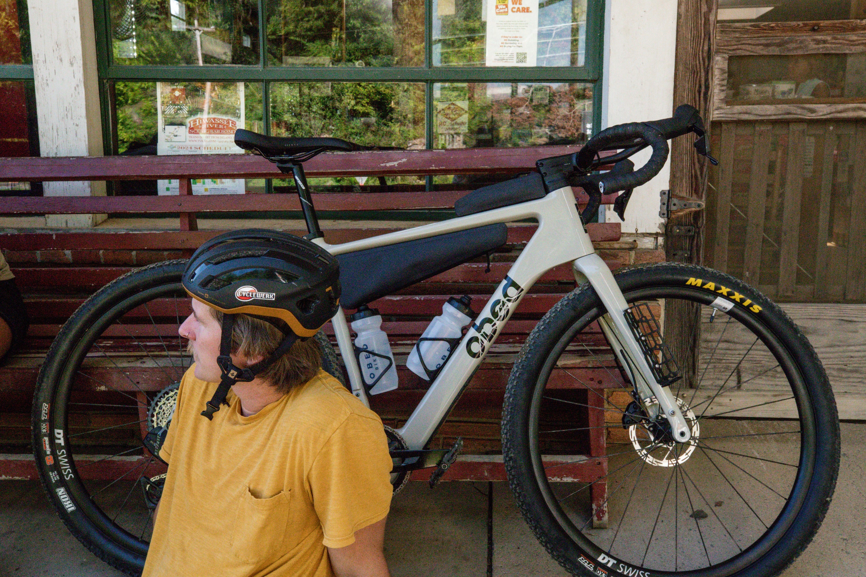 MMR Rider Taking a Break in front of a wooden building