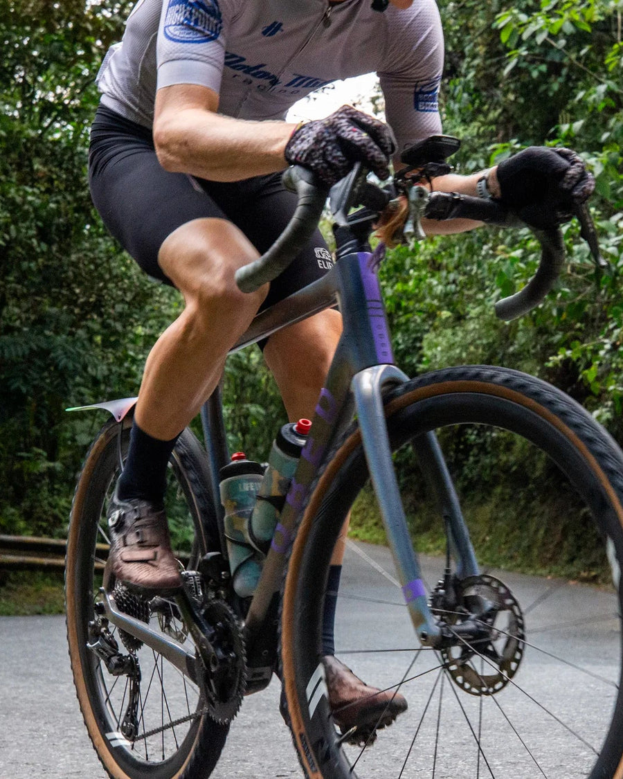 Person riding a GVR on a road surrounded by greenery