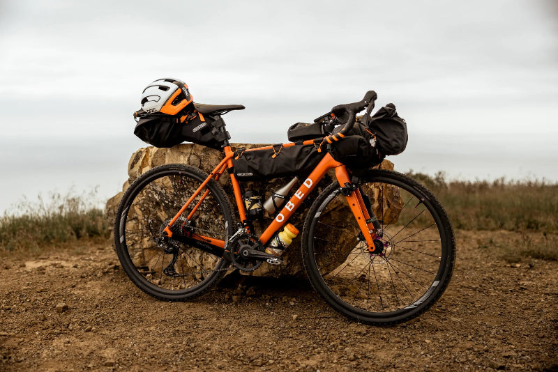 Orange bicycle with gear on a rocky terrain