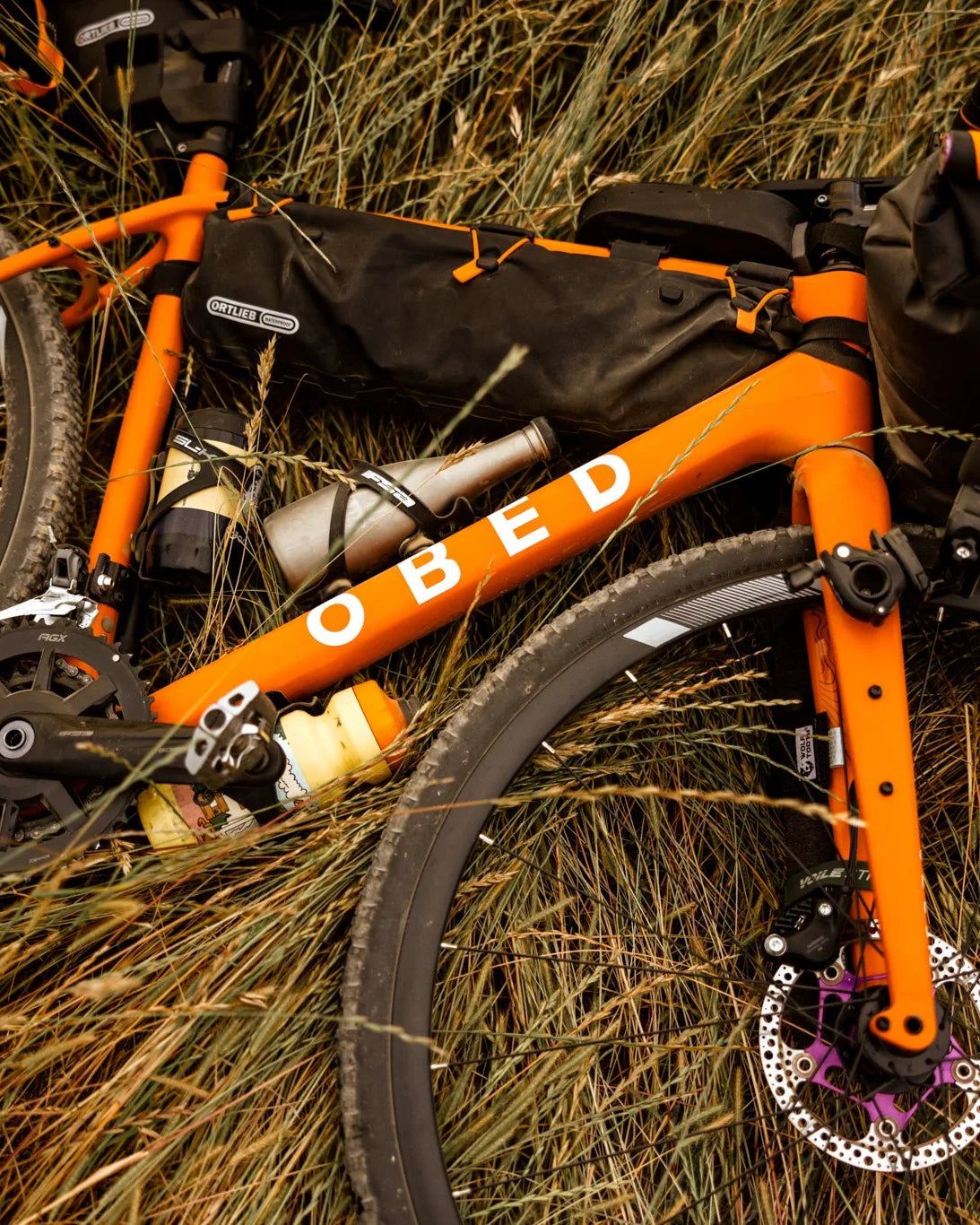 Orange GVR with black bags on a grassy background