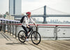 Man riding Obed Borough on dock with a river and city in the background